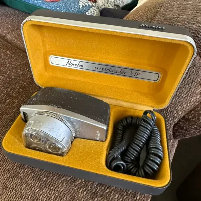 Sale Photo Thumbnail #621: Vintage Norelco Tripleheader VIP electric shaver housed in its original mustard-yellow velvet-lined hard case with power cord.