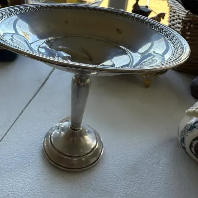 Sale Photo Thumbnail #387: Vintage silver-plated pedestal tazza dish featuring an embossed geometric border along the rim.
