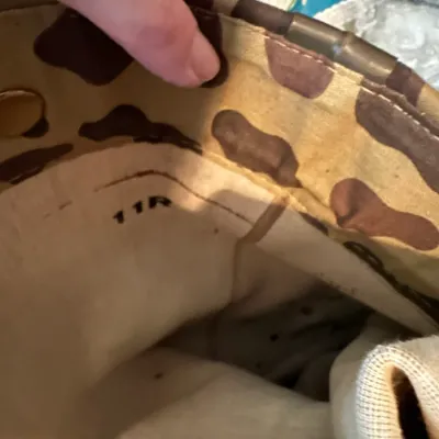 Sale Photo Thumbnail #615: Interior lining of a camouflage boot showing the stamped size marking 11R.