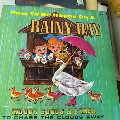 Sale Photo Thumbnail #126: Vintage children's vinyl record album titled "How To Be Happy On A Rainy Day," featuring colorful mid-century cover art.