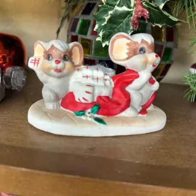 Sale Photo Thumbnail #307: Vintage painted ceramic Christmas figurine featuring two mice pulling a red bag filled with wrapped presents.