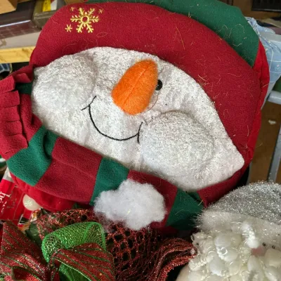 Sale Photo Thumbnail #292: Plush snowman head holiday decoration with a red embroidered winter hat, striped fleece scarf, and carrot nose.