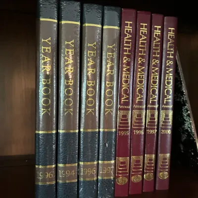 Sale Photo Thumbnail #648: Collection of Britannica Year Books and Health & Medical Annuals dating from 1994 to 2000, bound in faux-leather with gilded spine lettering.