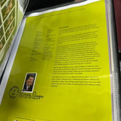 Sale Photo Thumbnail #99: USPS 2005 Ronald Reagan First Day of Issue commemorative stamp sheet housed in a protective binder sleeve.