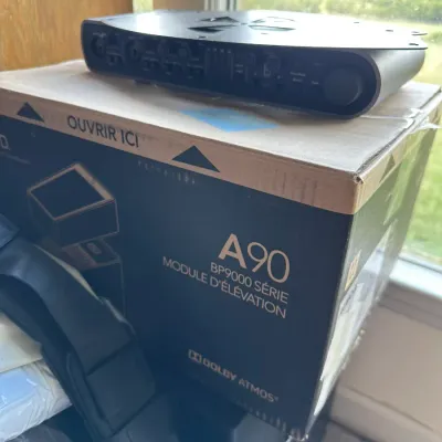 Sale Photo Thumbnail #150: Definitive Technology A90 BP9000 Series Dolby Atmos height speaker module in its original box, topped with an audio interface component.