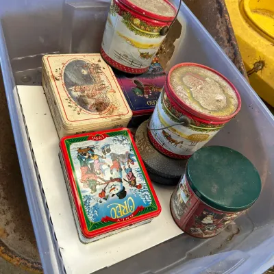 Sale Photo Thumbnail #564: Collection of vintage holiday tin containers, including a 1996 Oreo Christmas tin, stored inside a plastic tote bag.