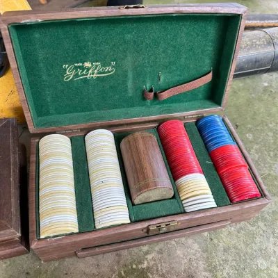 Sale Photo Thumbnail #156: Vintage Griffon brand wooden poker chip case, featuring a green felt-lined interior filled with interlocking plastic chips and a dice holder.