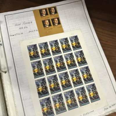Sale Photo Thumbnail #104: Collector binder page featuring sheets of US Forever postage stamps, including a block of 2012 José Ferrer stamps and a pane of 2012 Louisiana Statehood stamps.