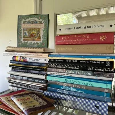Sale Photo Thumbnail #260: Large stack of vintage and contemporary cookbooks, featuring regional recipes, holiday themes, and health-focused titles.