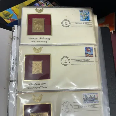 Sale Photo Thumbnail #96: Collection of Postal Commemorative Society 22kt gold replica first day covers from the 1990s, housed in clear binder sleeves.