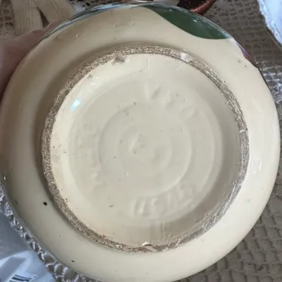 Sale Photo Thumbnail #589: Underside of a vintage ceramic bowl, featuring an impressed McCoy Pottery mark and model number on the unglazed foot ring.
