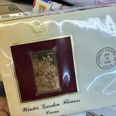 Sale Photo Thumbnail #102: Postal Commemorative Society 22kt gold replica stamp first day cover, featuring the 1996 32-cent Winter Garden Flowers Crocus stamp with postmark dated January 19, 1996.
