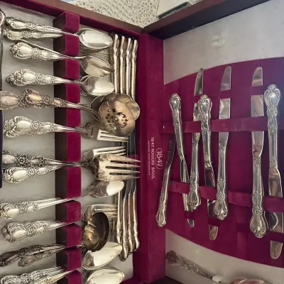 Sale Photo Thumbnail #204: Vintage 1847 Rogers Bros. silverplate flatware set with ornate floral pattern in a wooden, velvet-lined storage chest.