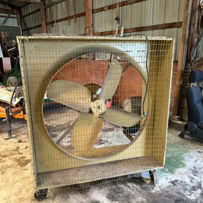 Sale Photo Thumbnail #566: Large industrial barn exhaust fan housed in a yellow wooden cabinet on casters.