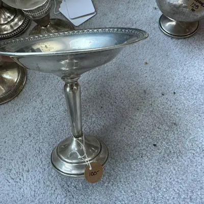 Sale Photo Thumbnail #402: Vintage silver-plated tall pedestal candy dish featuring a patterned rim and a stepped circular base.