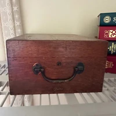 Sale Photo Thumbnail #412: Vintage Globe wooden index card file box featuring a hinged lid, metal drop handle, keyhole, and box-jointed construction.