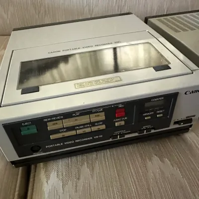 Sale Photo Thumbnail #463: Vintage Canon Portable Video Recorder model VR-10 VHS deck in silver and black casing, circa 1980s.