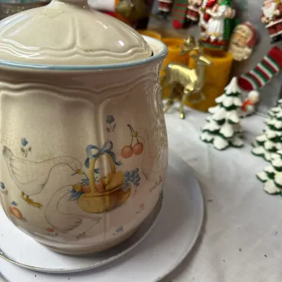 Sale Photo Thumbnail #20: Vintage country-style ceramic canister with lid, featuring a geese and fruit basket motif with blue trim.
