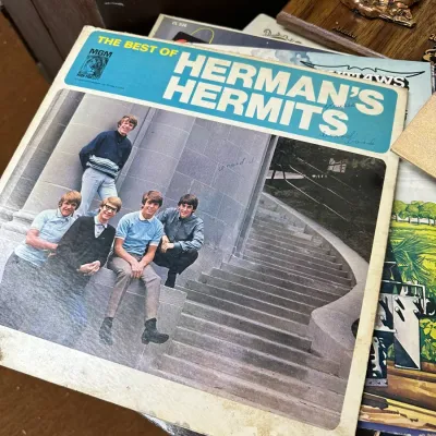 Sale Photo Thumbnail #128: Vintage 1966 vinyl LP album, "The Best of Herman's Hermits" on MGM Records, showing cover wear and handwritten markings.
