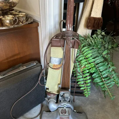 Sale Photo Thumbnail #667: Vintage Kirby Classic III upright vacuum cleaner with woodgrain trim and cloth bag.