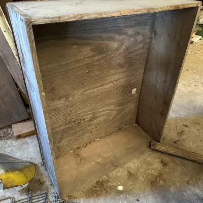 Sale Photo Thumbnail #220: Large rustic handmade wooden crate or open-front storage box, showing weathered grain, visible wear, and dust.