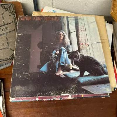 Sale Photo Thumbnail #119: Carole King "Tapestry" vinyl record album released in 1971, showing ring wear and edge scuffing on the cover.