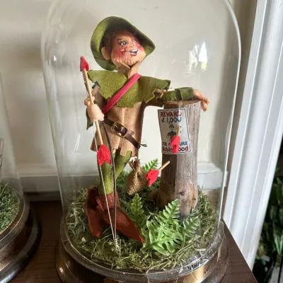 Sale Photo Thumbnail #593: Annalee Dolls Folk Hero Series Robin Hood doll displayed under a glass cloche dome, dated 1984.