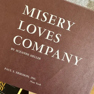 Sale Photo Thumbnail #456: Copy of Misery Loves Company by Suzanne Heller, published by Paul S. Eriksson, Inc., featuring a brown textured paper cover with white lettering.