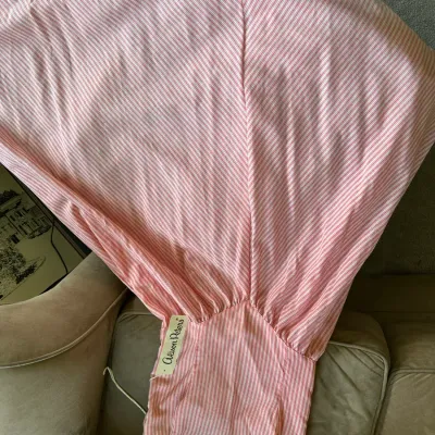 Sale Photo Thumbnail #624: Vintage Alison Peters pink and white striped garment with a gathered design, laid across a chair.