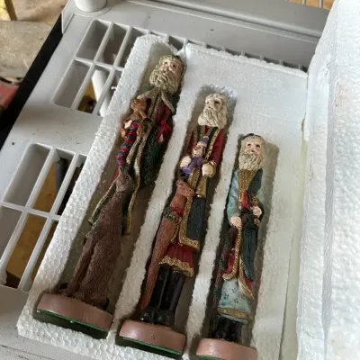 Sale Photo Thumbnail #572: Set of three vintage-style resin Santa Claus figurines in original styrofoam packaging. Each slender Santa features detailed robes and holiday accents in good condition.