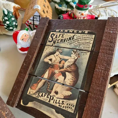 Sale Photo Thumbnail #161: Vintage small wooden crate end featuring a reproduction label for Warner's Safe Nervine patent medicine.