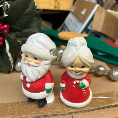Sale Photo Thumbnail #293: Pair of vintage mid-century painted ceramic Santa and Mrs. Claus salt and pepper shakers.