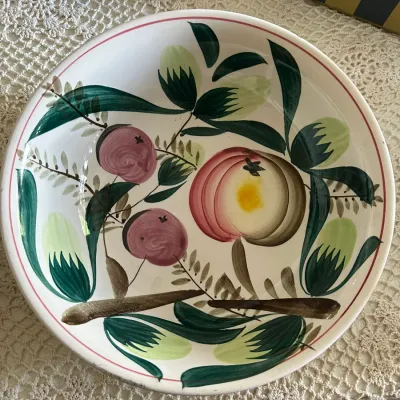 Sale Photo Thumbnail #586: Vintage hand-painted ceramic fruit bowl featuring a botanical motif with apples and leafy branches against a white backdrop.