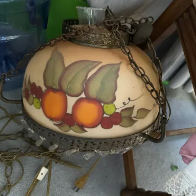 Sale Photo Thumbnail #374: Vintage hand-painted glass swag lamp featuring a fruit motif with metal filigree trim and a hanging chain.