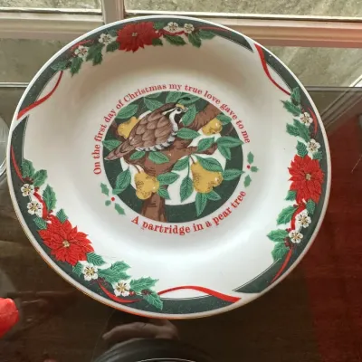 Sale Photo Thumbnail #231: Holiday ceramic serving bowl featuring a "partridge in a pear tree" design with a poinsettia and ribbon border.