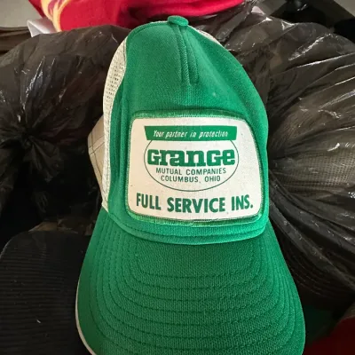 Sale Photo Thumbnail #602: Vintage green and white Grange Mutual Companies trucker hat with mesh back and embroidered patch.