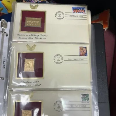 Sale Photo Thumbnail #97: Set of 1997 Postal Commemorative Society First Day Covers featuring 22kt gold replica stamps, housed in clear binder sleeves.