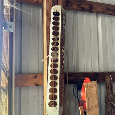 Sale Photo Thumbnail #715: Vintage galvanized metal poultry chick feeder tray hanging vertically on a barn wall.