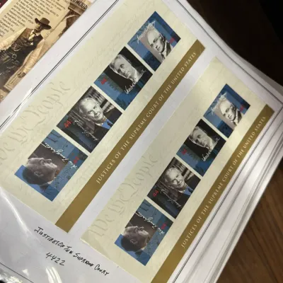 Sale Photo Thumbnail #109: Stamp collection album page featuring USPS "Justices of the Supreme Court of the United States" 44-cent commemorative stamp sheets.