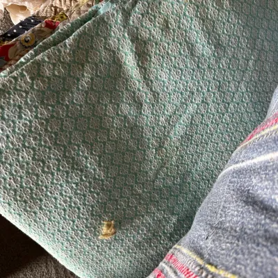 Sale Photo Thumbnail #355: Folded light mint green textile fabric featuring a small geometric repeating pattern.