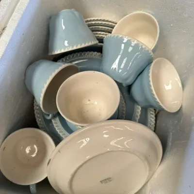 Sale Photo Thumbnail #574: Collection of light blue and cream ceramic teacups and matching saucers packed in a box, featuring a beaded edge design.