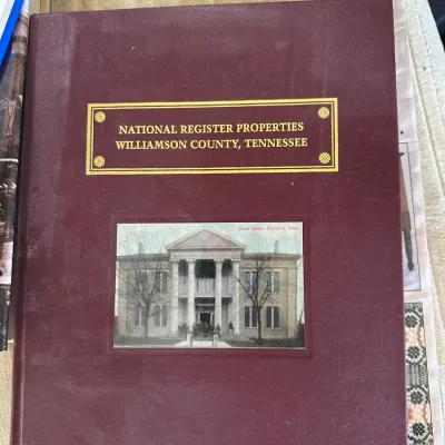 Sale Photo Thumbnail #425: Hardcover copy of 'National Register Properties Williamson County, Tennessee', featuring a maroon cloth cover with gold lettering and an inset image of the Franklin, Tennessee courthouse.