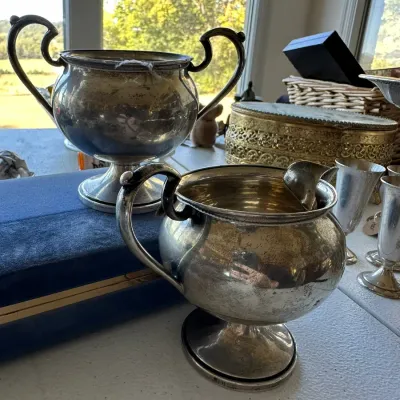 Sale Photo Thumbnail #391: Vintage silver-plated creamer and double-handled sugar bowl set with a rounded pedestal design.