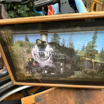 Sale Photo Thumbnail #48: Vintage framed shadowbox wall clock featuring a steam locomotive print with gold-toned filigree trim and numerals.