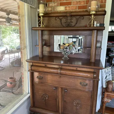 Sale Photo Thumbnail #452: Antique oak server sideboard with an mirrored upper hutch, carved details, and claw feet.