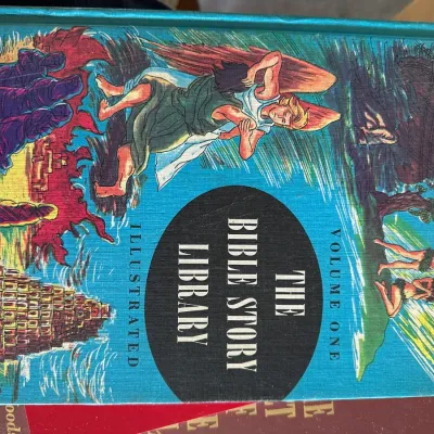 Sale Photo Thumbnail #460: Vintage copy of "The Bible Story Library Illustrated Volume One," featuring a bright blue cloth cover with colorful pictorial illustrations.
