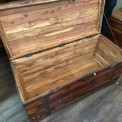 Sale Photo Thumbnail #348: Rustic cedar-lined wooden trunk featuring metal corner bracket accents and chain lid supports.