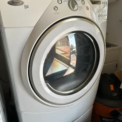 Sale Photo Thumbnail #155: Whirlpool Duet front-load electric dryer in white, showing light cosmetic wear on the front door panel.