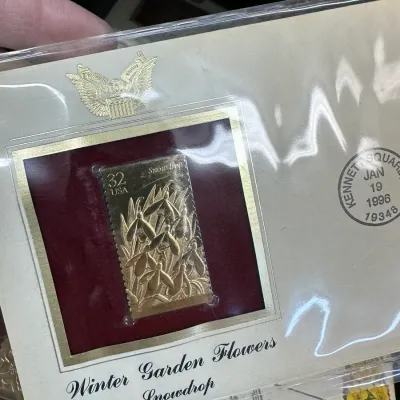 Sale Photo Thumbnail #101: 1996 USPS Winter Garden Flowers Snowdrop First Day Cover featuring a 22kt gold replica stamp in protective plastic sleeve.