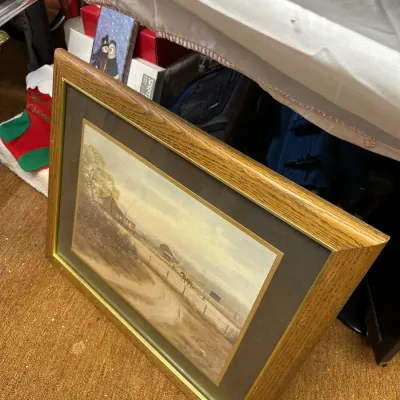 Sale Photo Thumbnail #25: Framed landscape print depicting a rural farm scene, housed in a thick oak wood frame with dark matting.